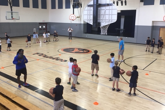 4th-grade parents helping with basketball workshops as a vehicle to teach important teamwork and sportsmanship skills.